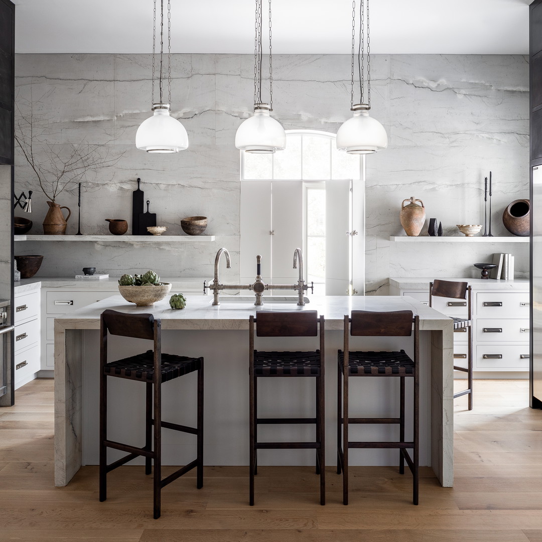 a kitchen with a center island with stools