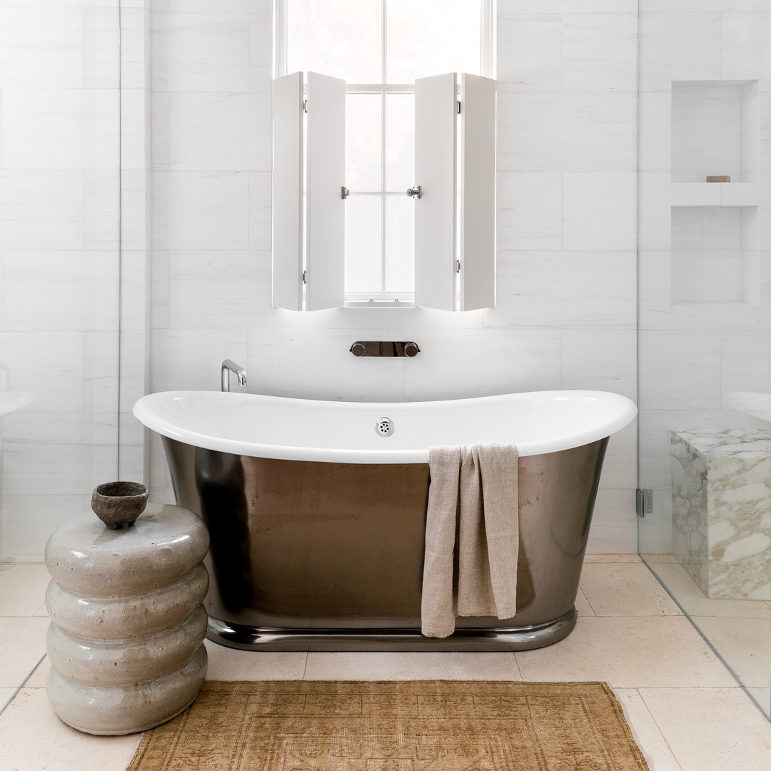 a bathroom with a claw foot tub and a rug