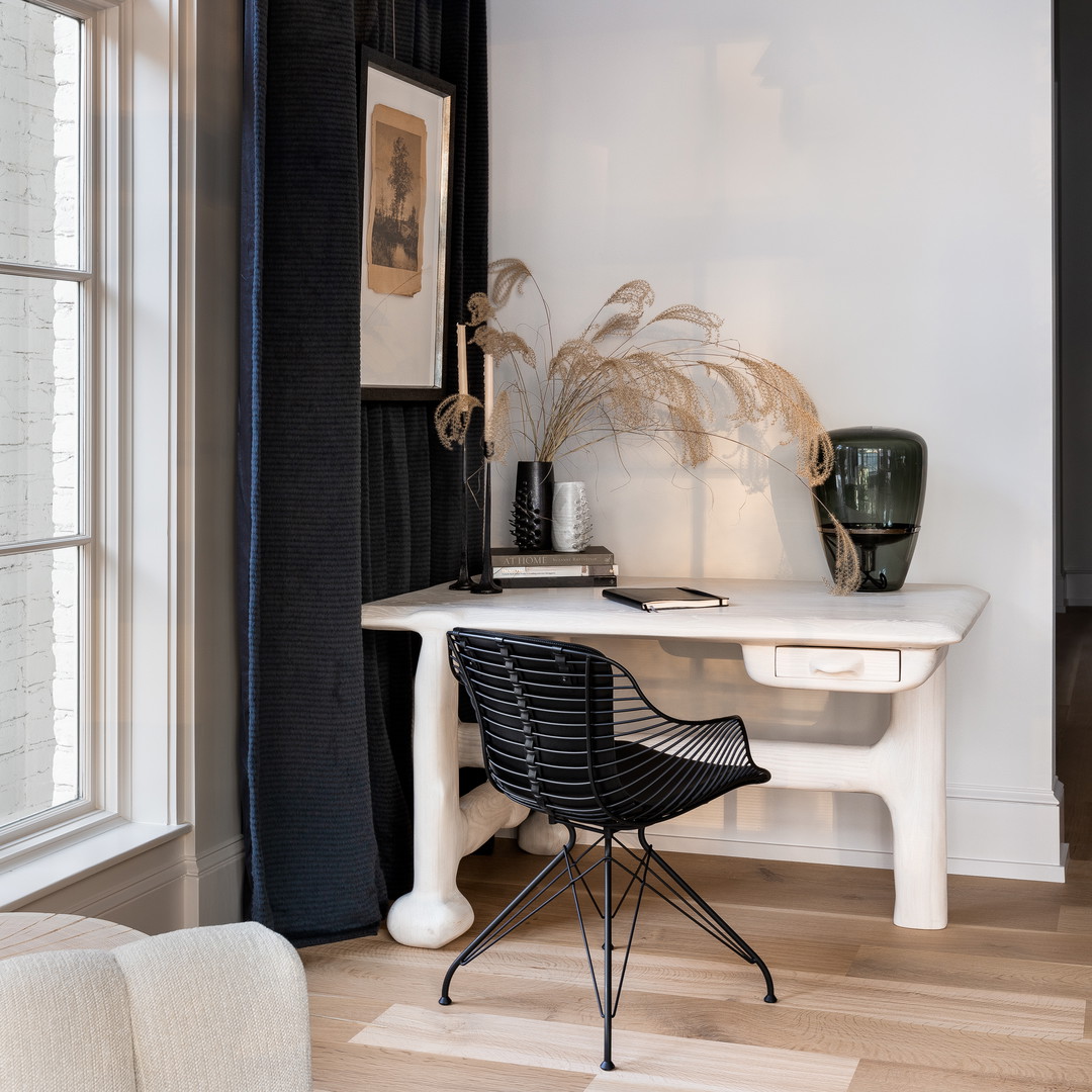 a white desk with a black chair next to it