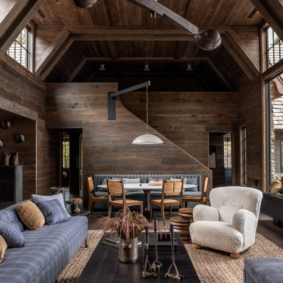 a living room filled with furniture and wooden walls