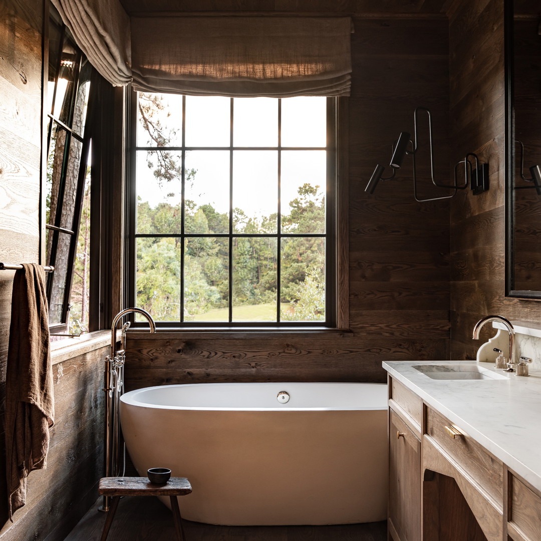 a bathroom with a tub and a window