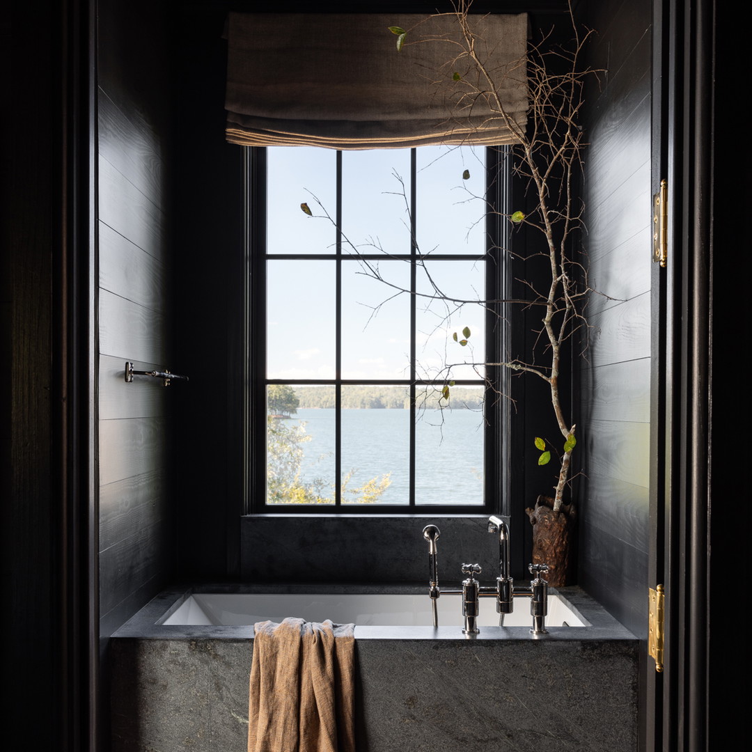 a bathroom with a tub and a window