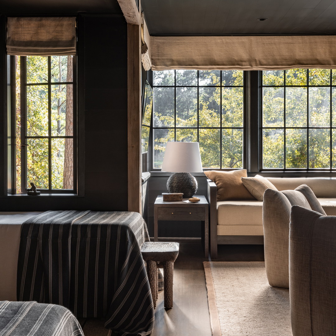 a living room filled with furniture and windows