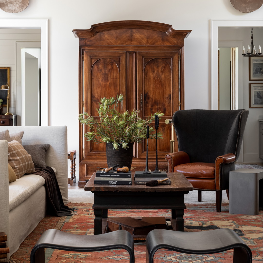 a living room filled with furniture and a wooden cabinet