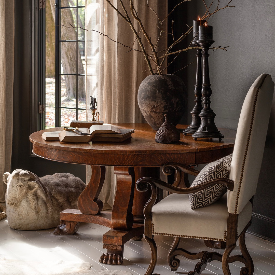 a room with a table, chairs, and a vase