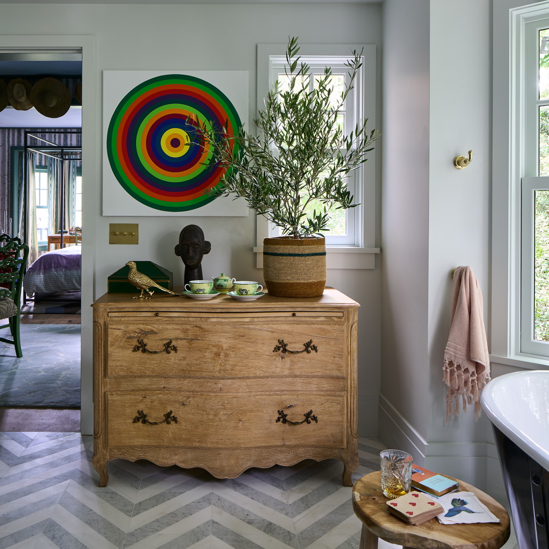 a wooden dresser sitting in a bathroom next to a window