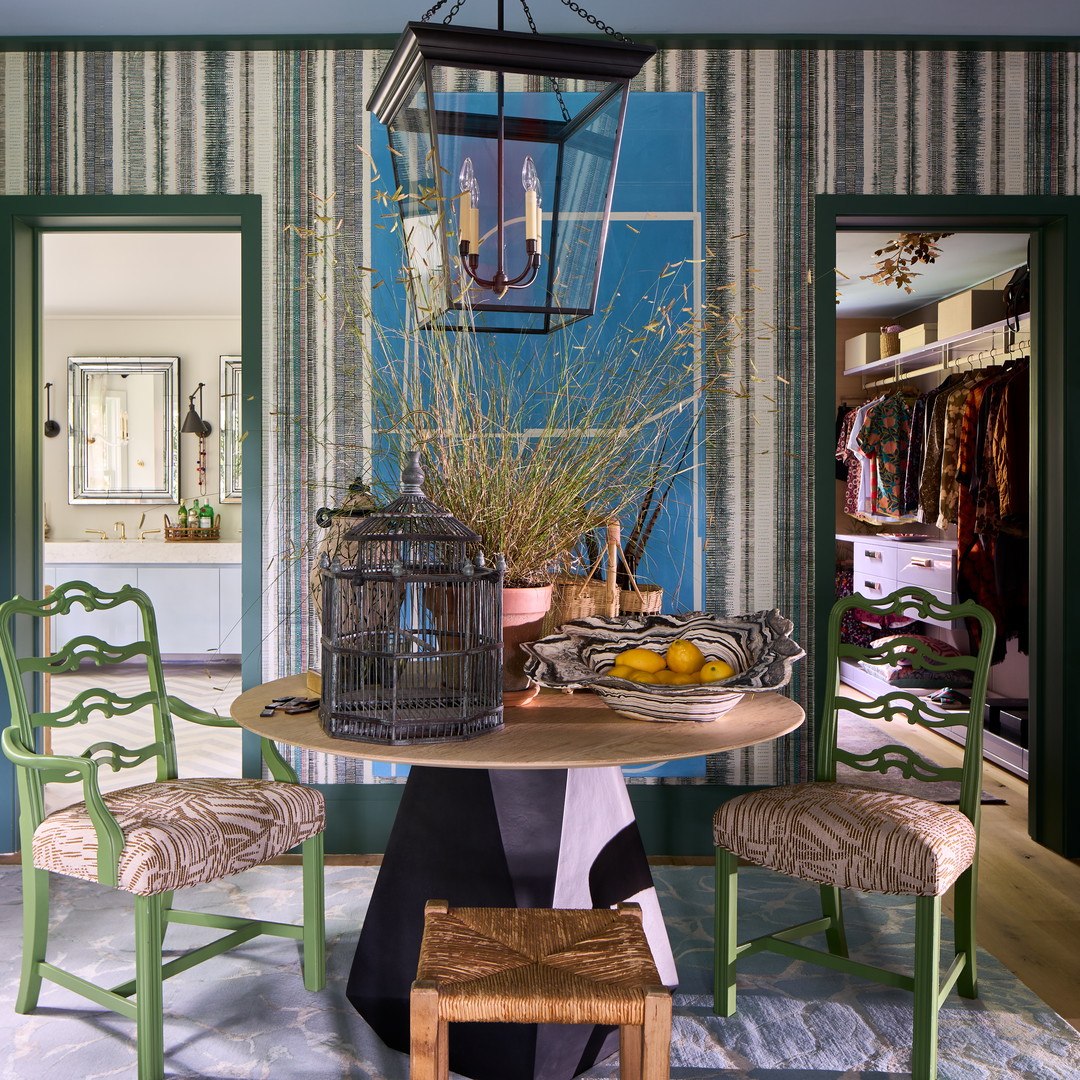 a dining room with a birdcage hanging from the ceiling