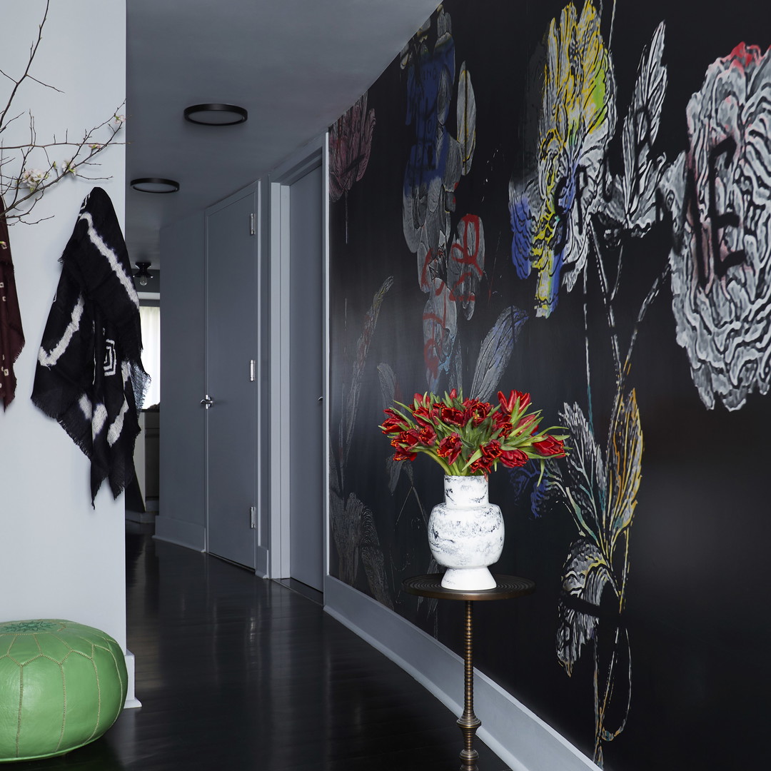 a hallway with a vase of flowers on a table