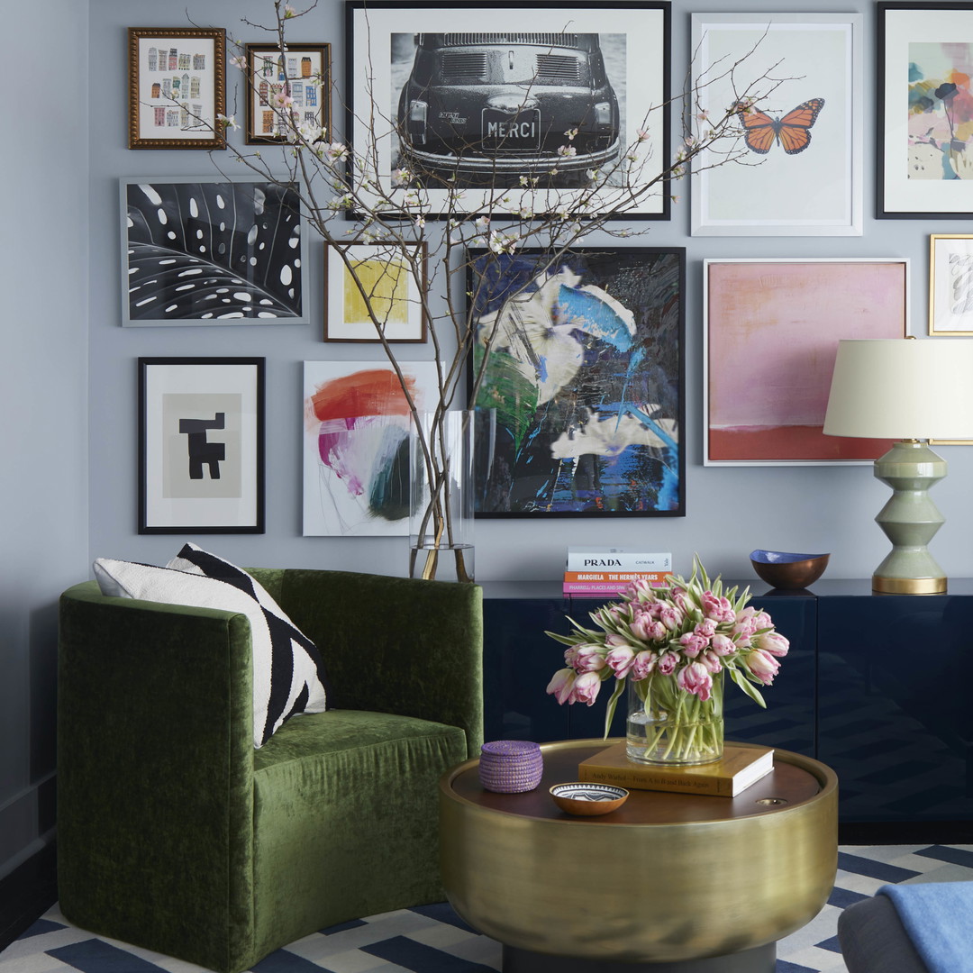 a living room filled with furniture and pictures on the wall