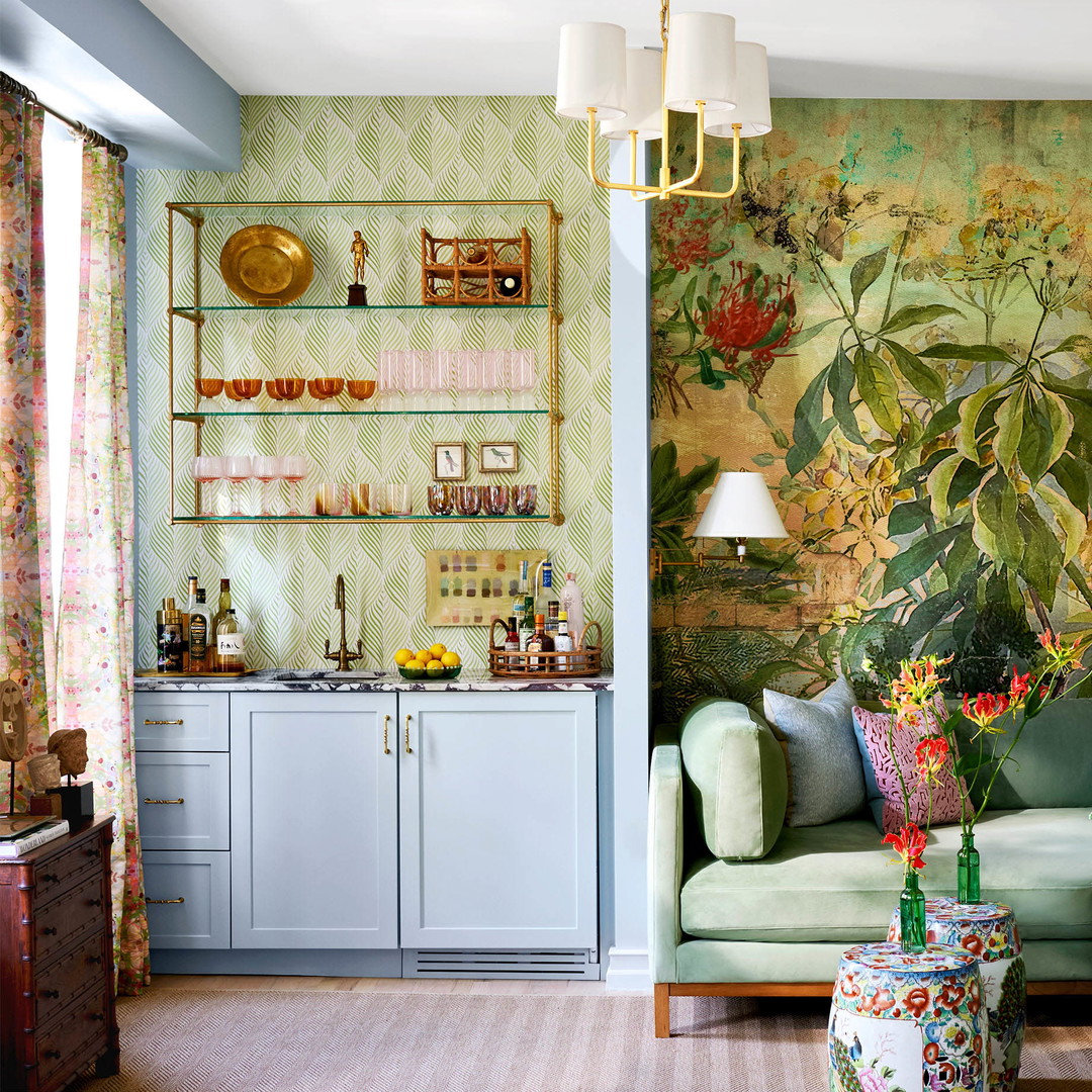 a living room filled with furniture and a painting on the wall