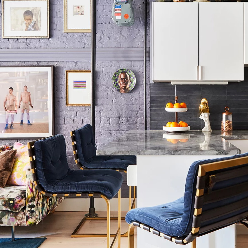 a kitchen with a marble counter top and chairs