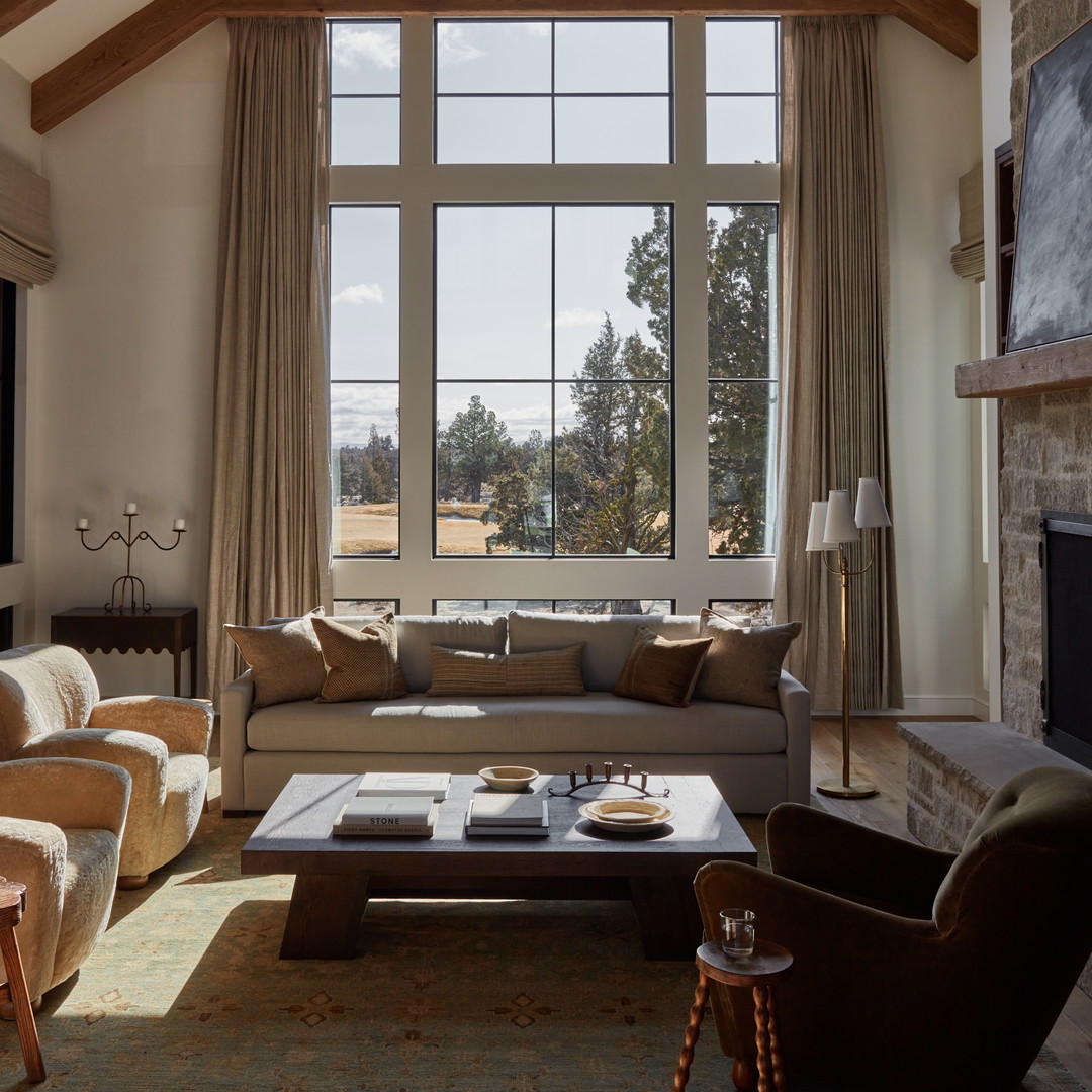 a living room filled with furniture and a large window