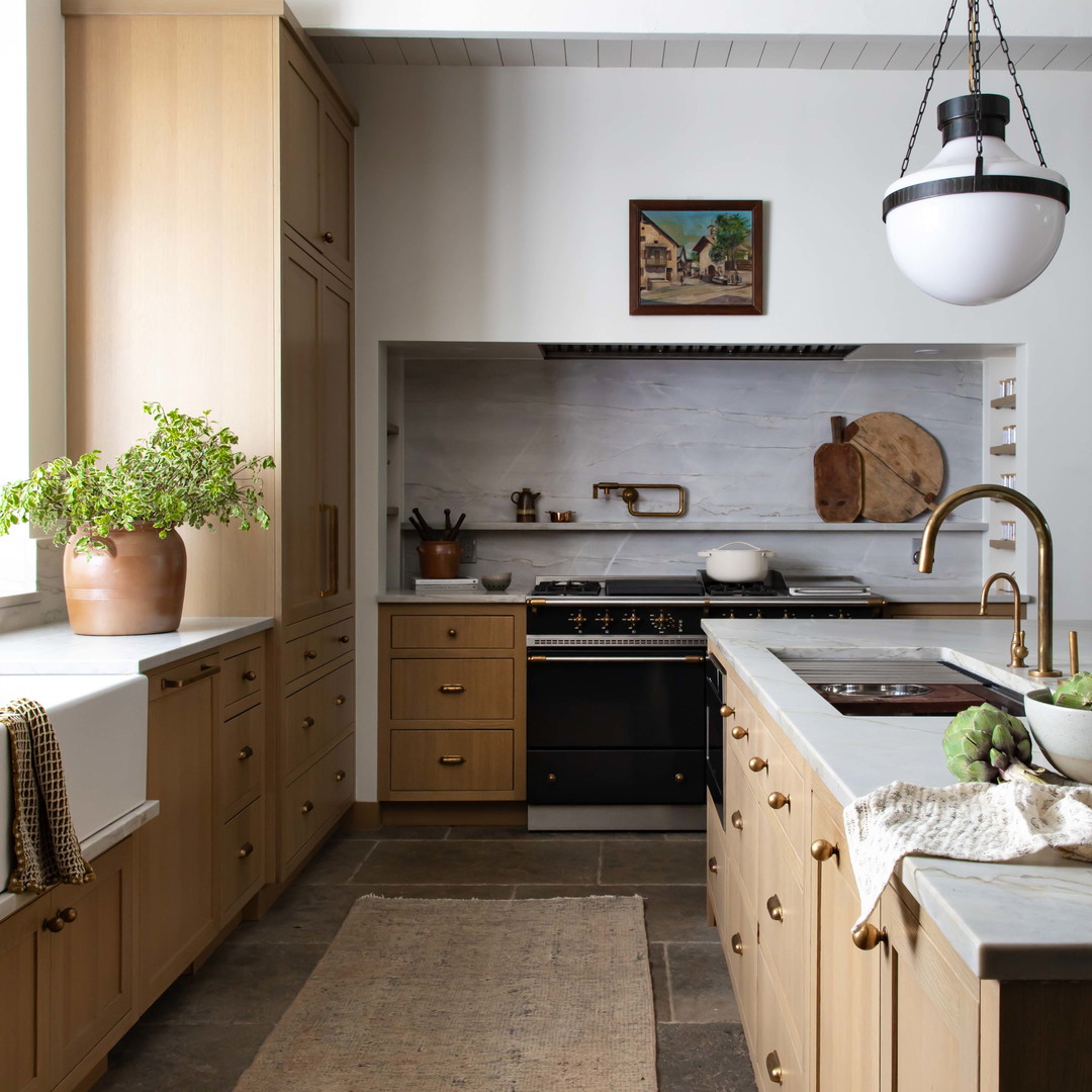 a kitchen with a sink, stove, oven and a rug