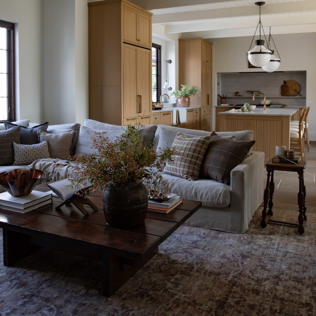 a living room filled with furniture and a large window