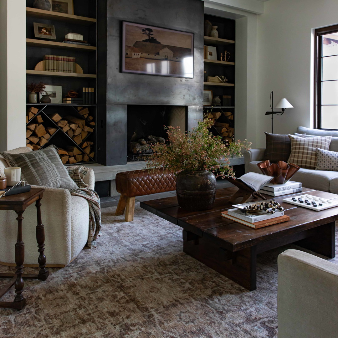 a living room filled with furniture and a fire place