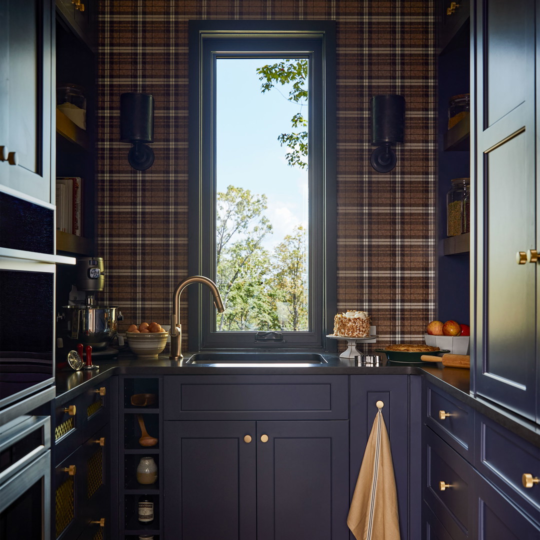 a kitchen with blue cabinets and a window