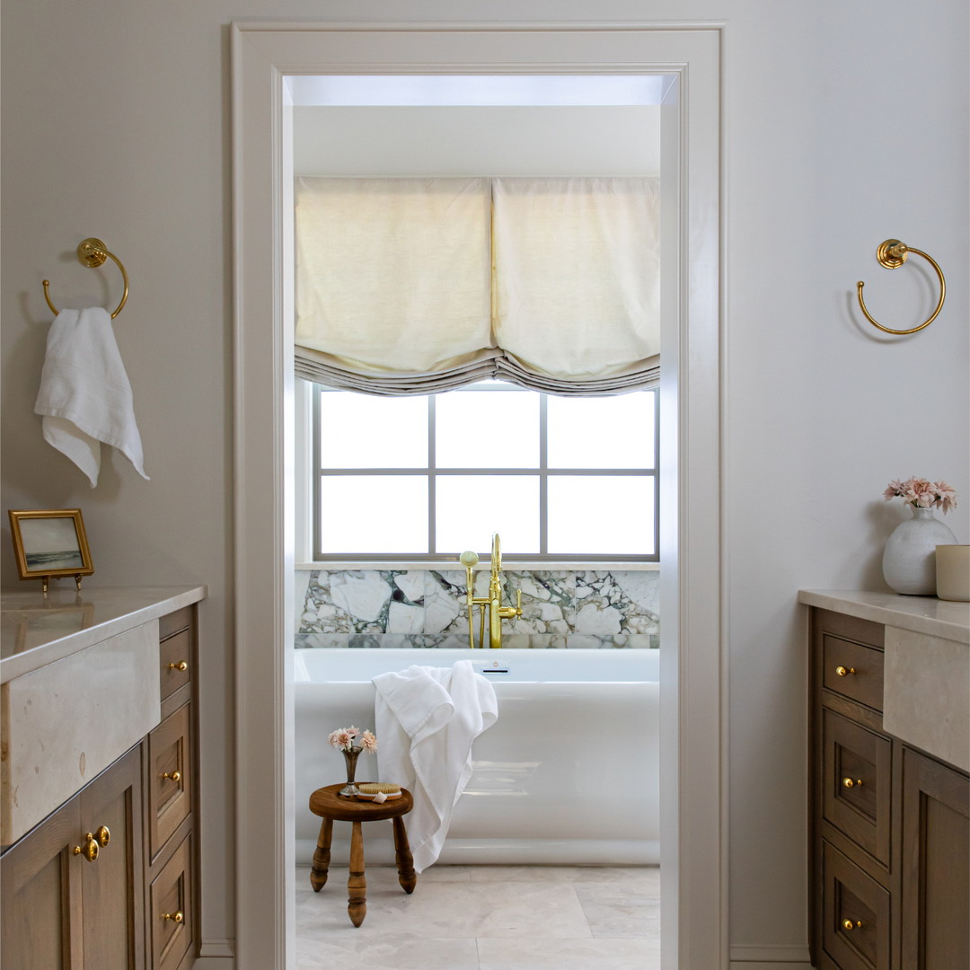 a bathroom with a bathtub and a rug on the floor