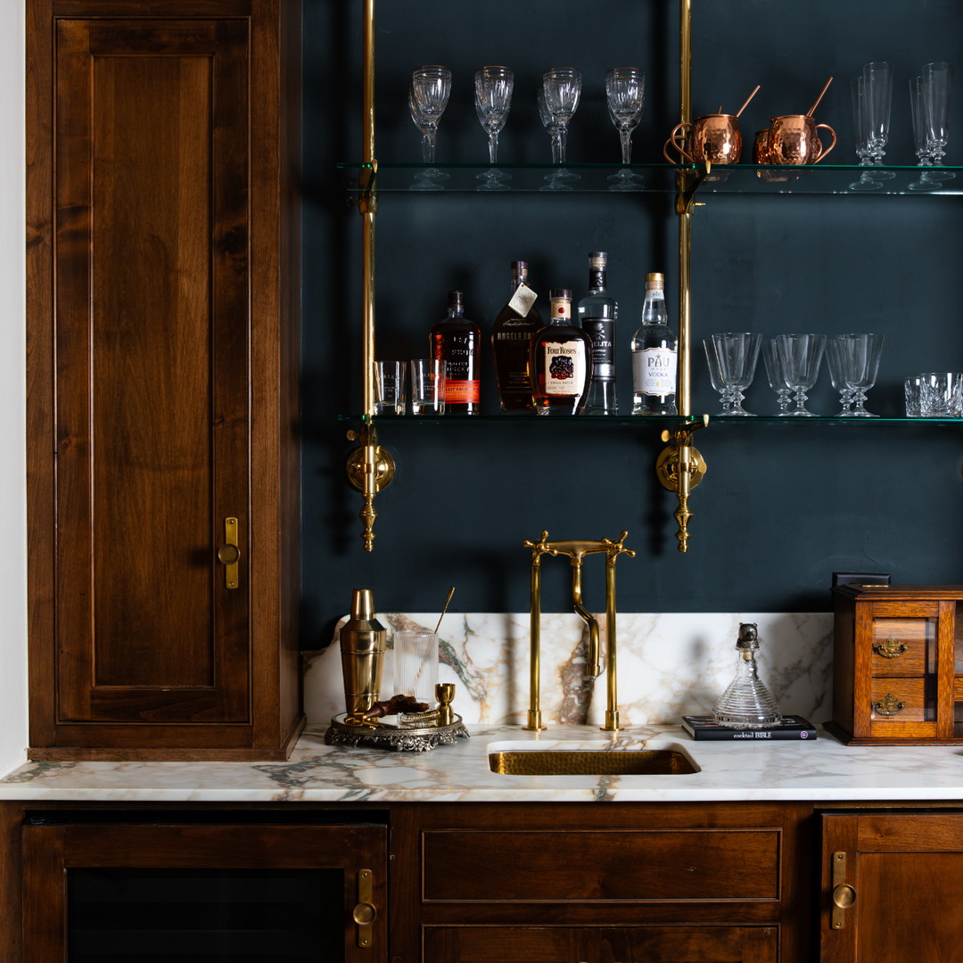 a kitchen with a marble counter top and wooden cabinets