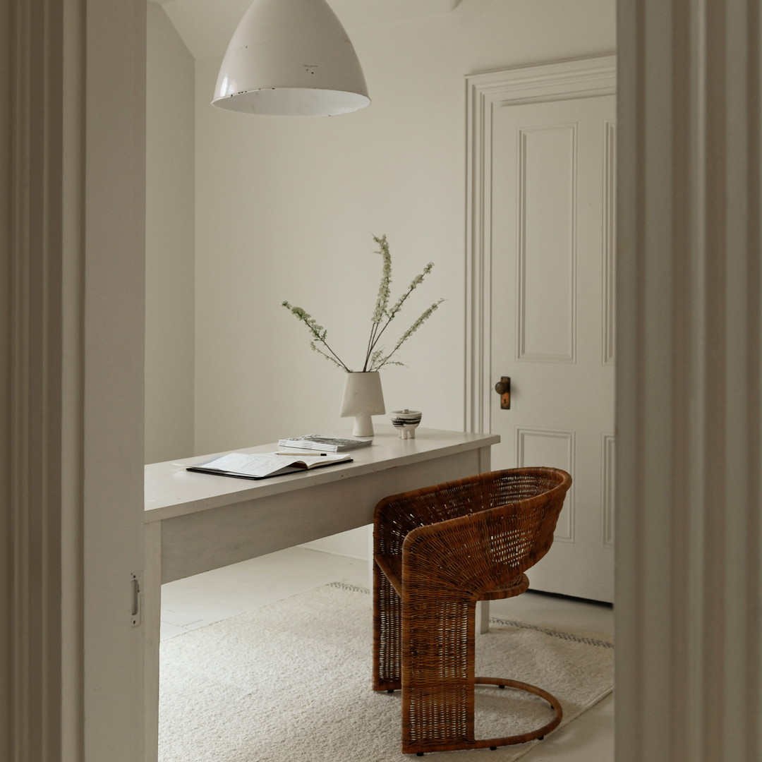 a white room with a desk and a chair