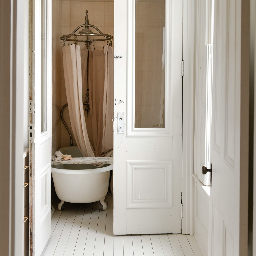 a bathroom with a tub and a door