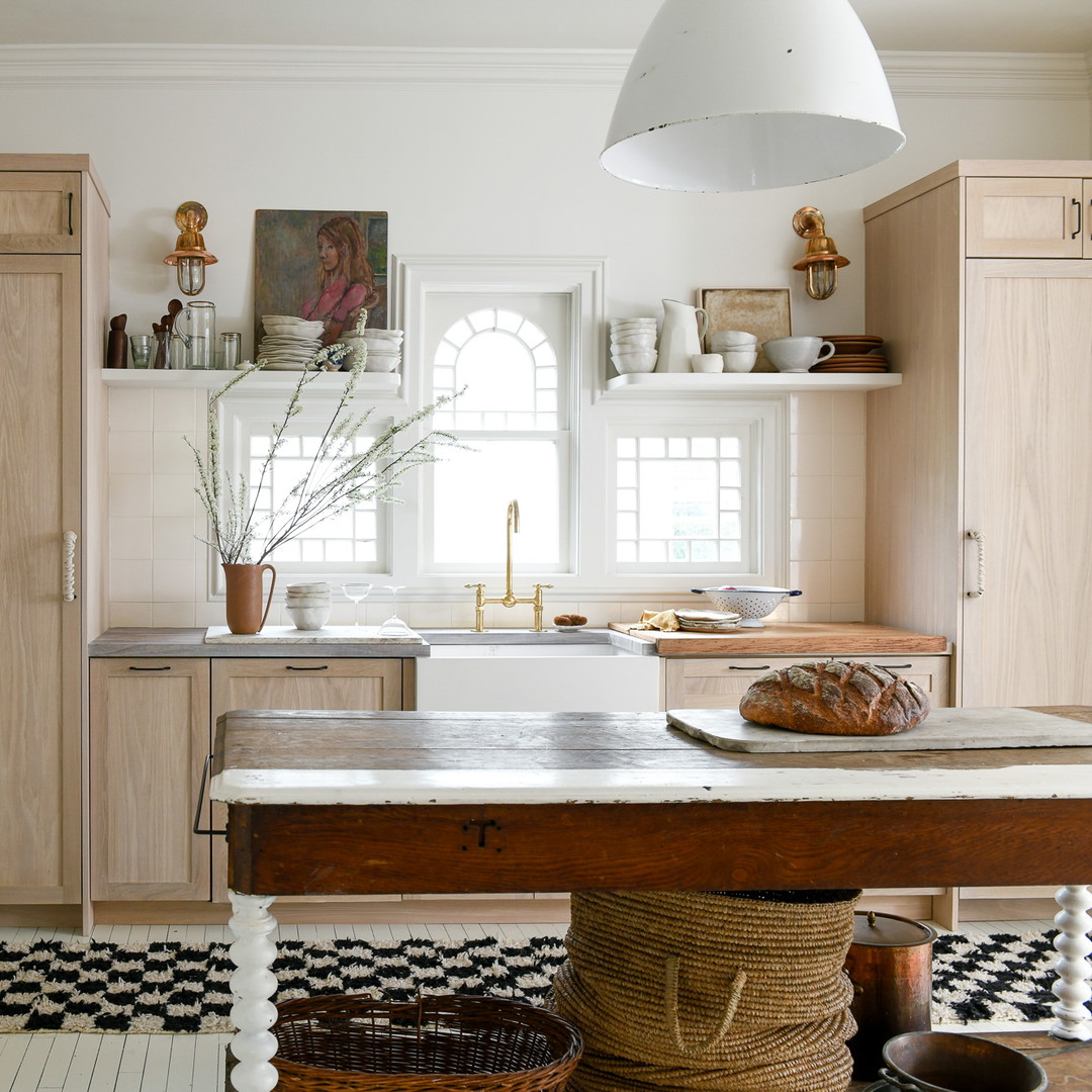 a kitchen with wooden cabinets and a checkered floor