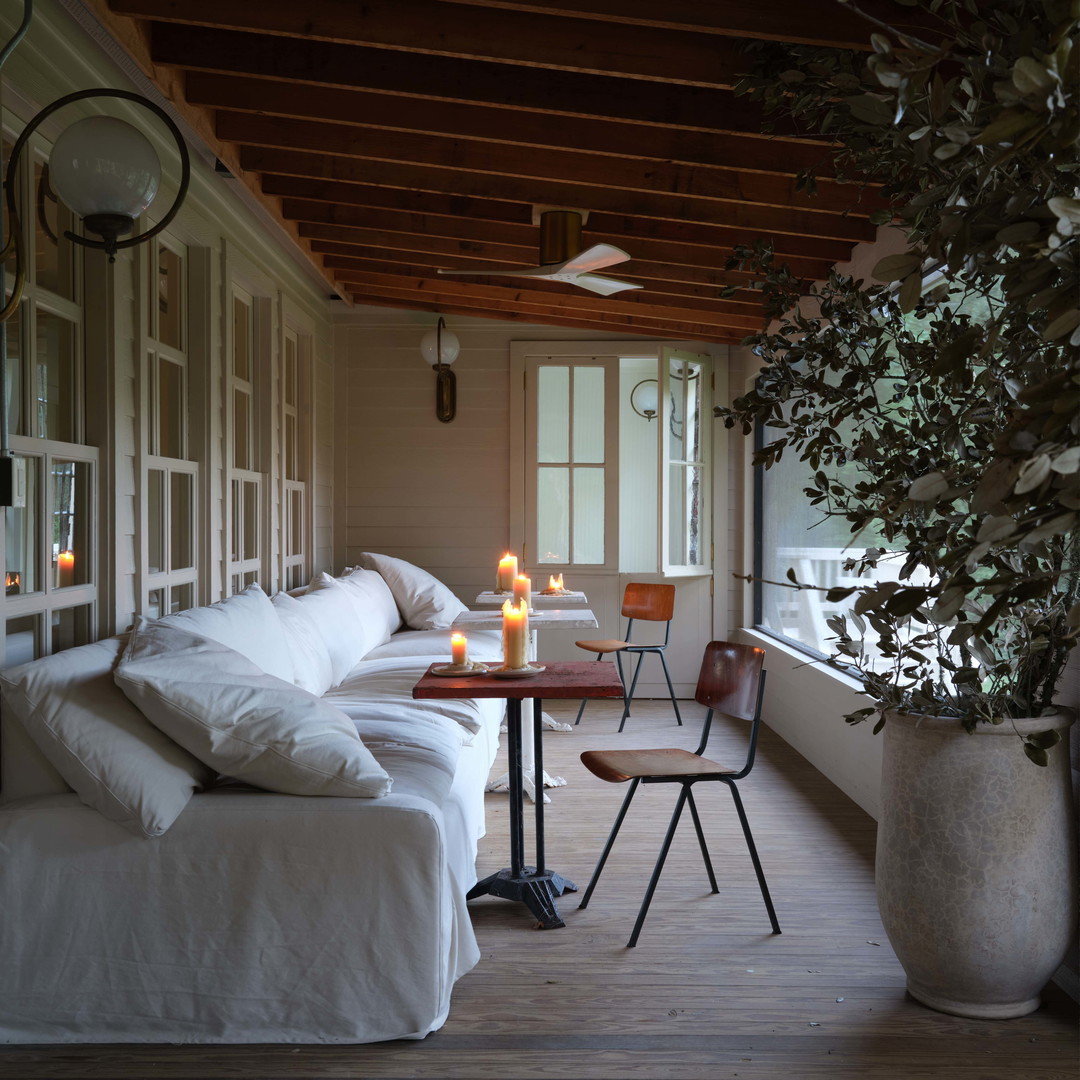 a living room with a couch and a table with candles on it