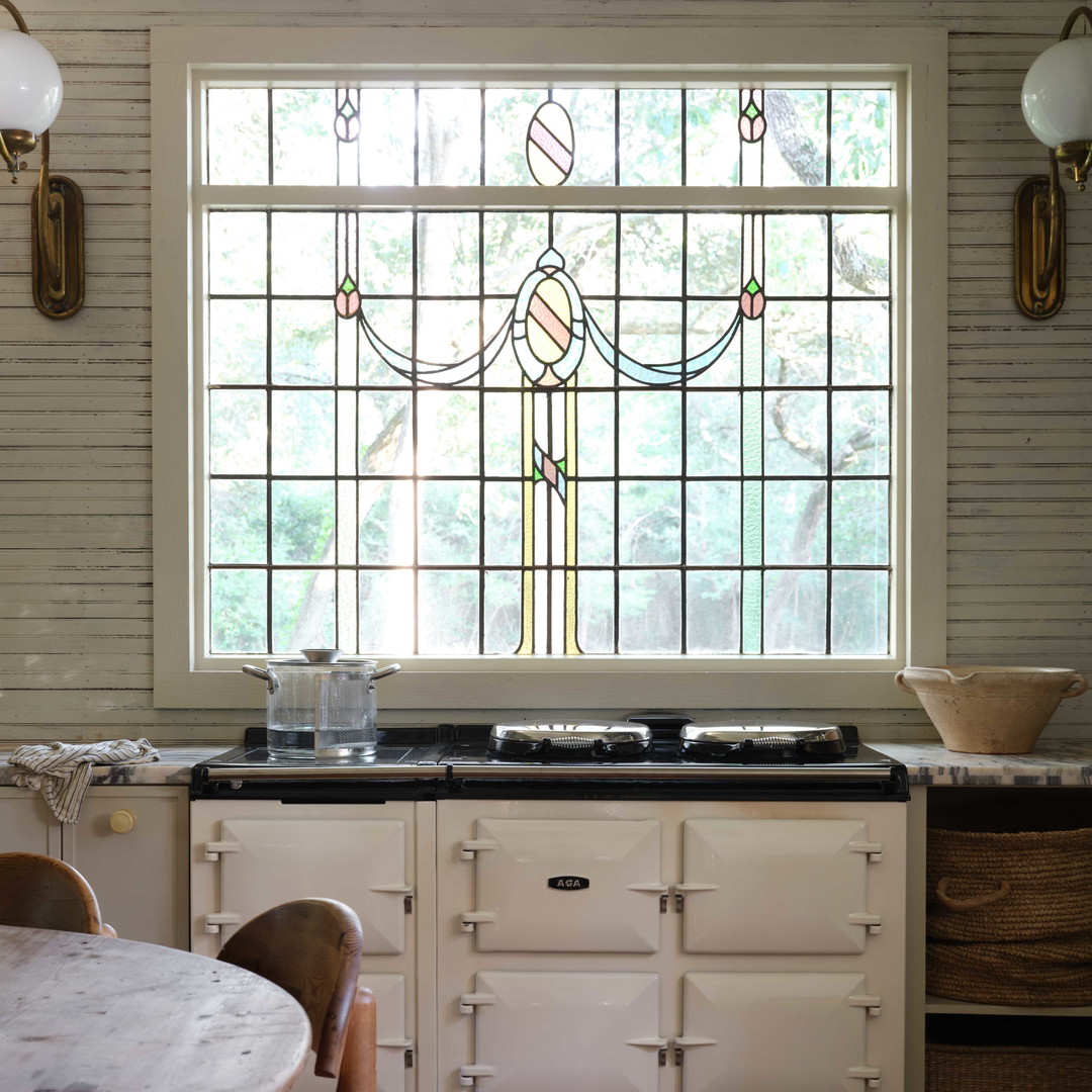 a kitchen with a stove top oven next to a window