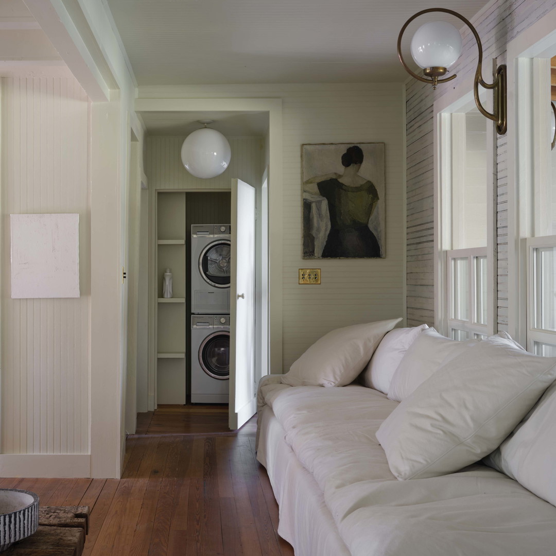 a living room filled with furniture and a hard wood floor