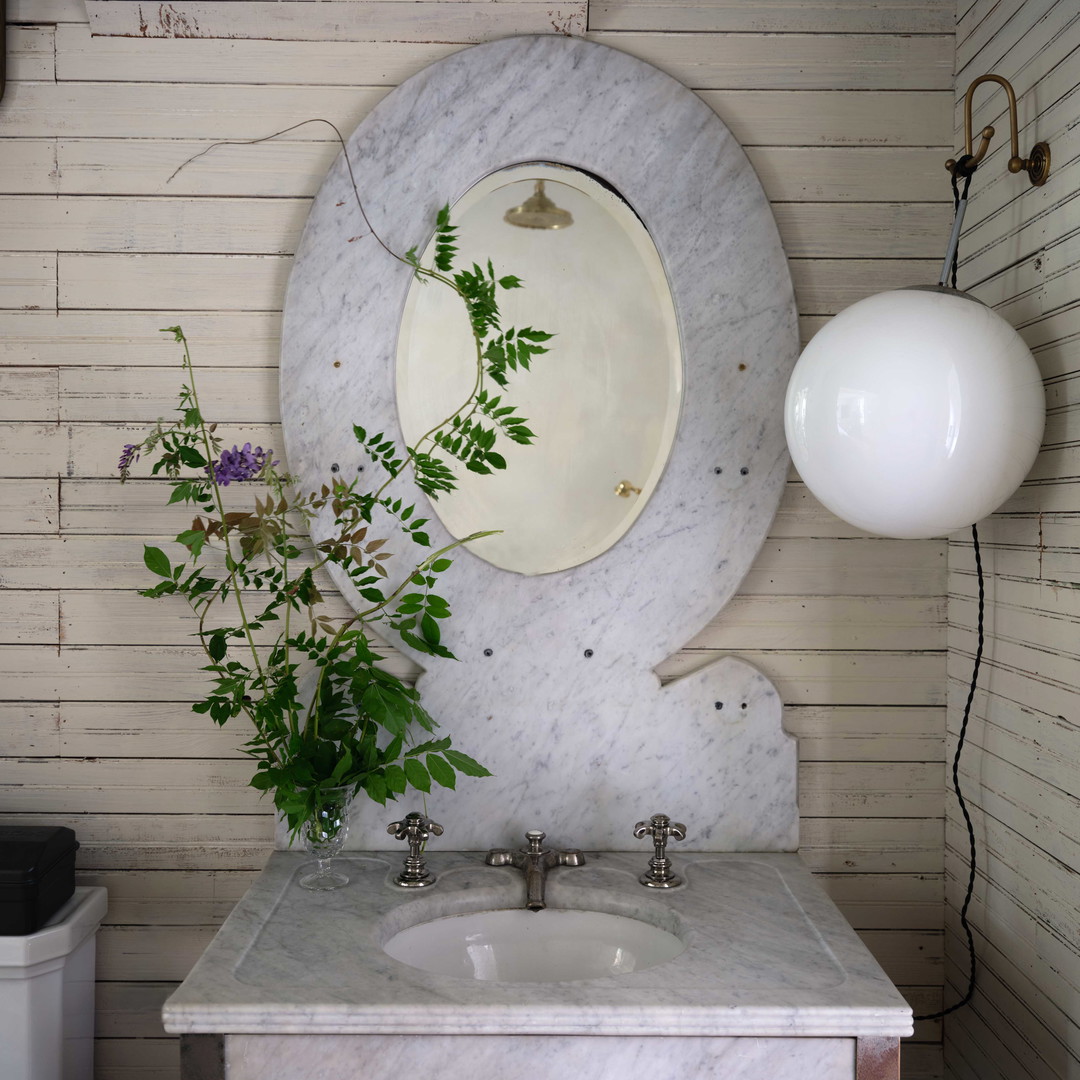 a bathroom with a marble sink and mirror