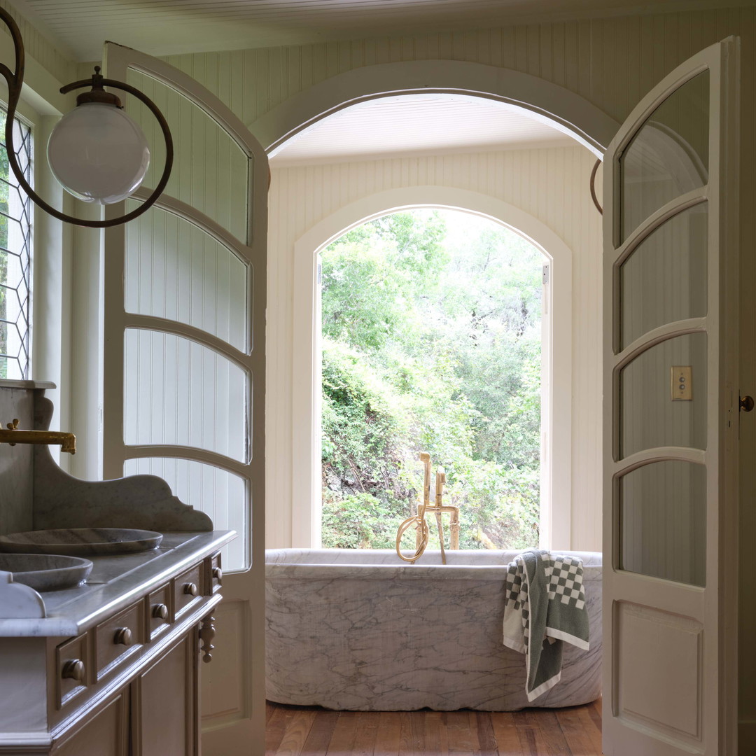 a bathroom with a large window and a tub