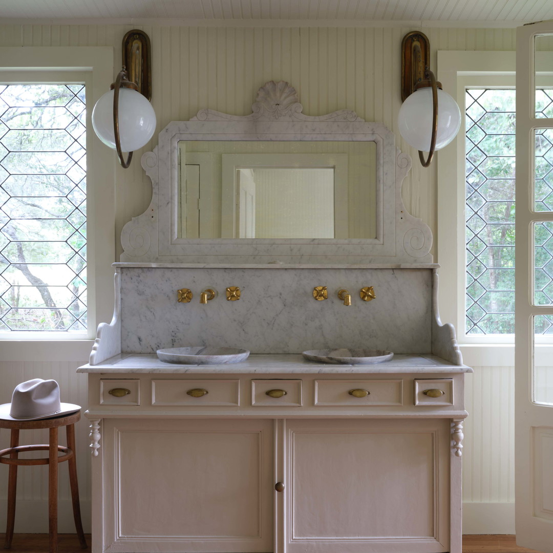 a bathroom with two sinks and a large mirror