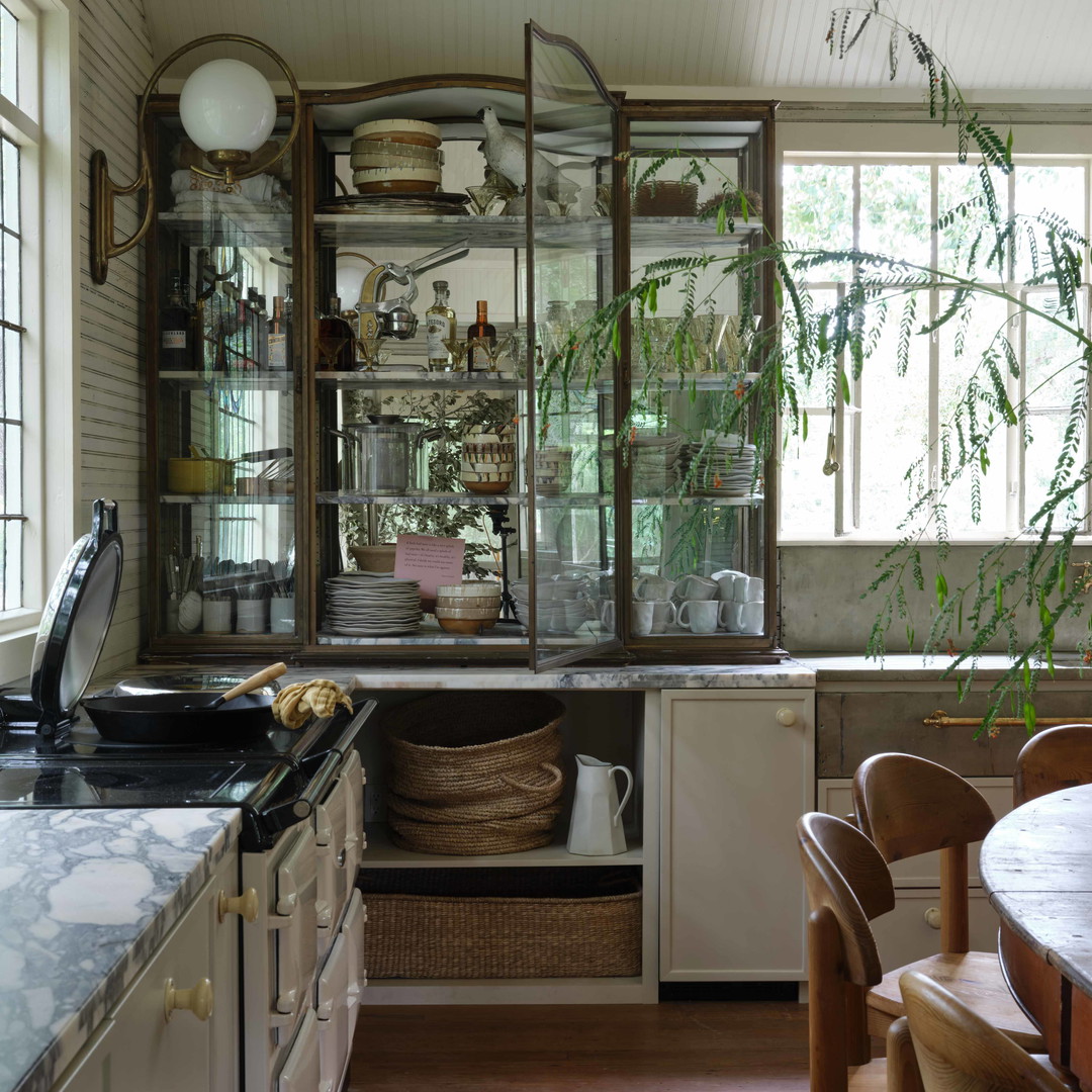 a kitchen filled with lots of wooden furniture