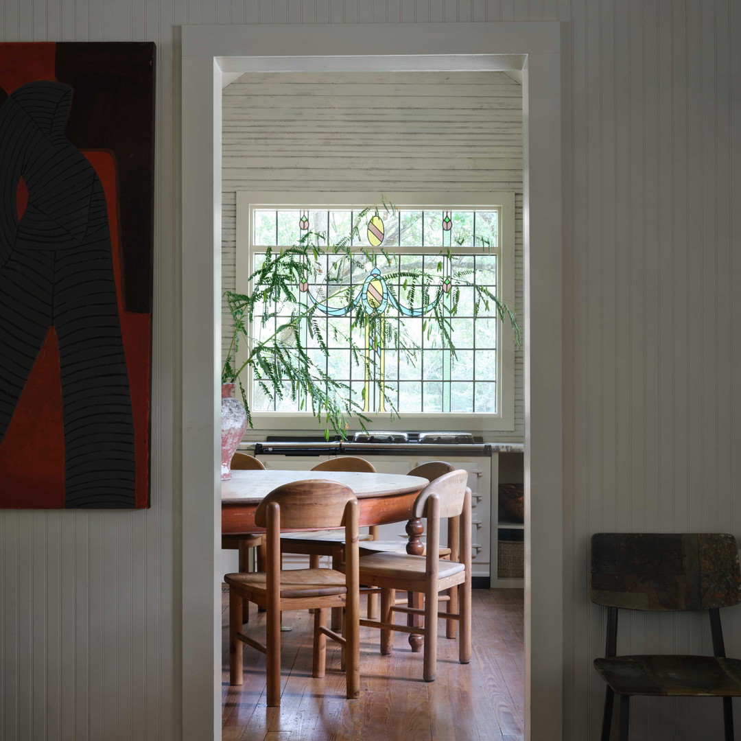 a dining room with a table and chairs