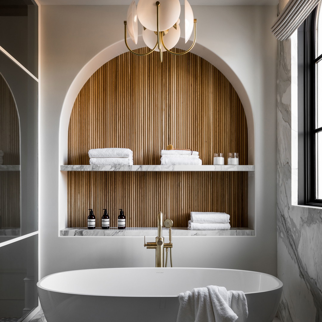 a large white bath tub sitting under a window