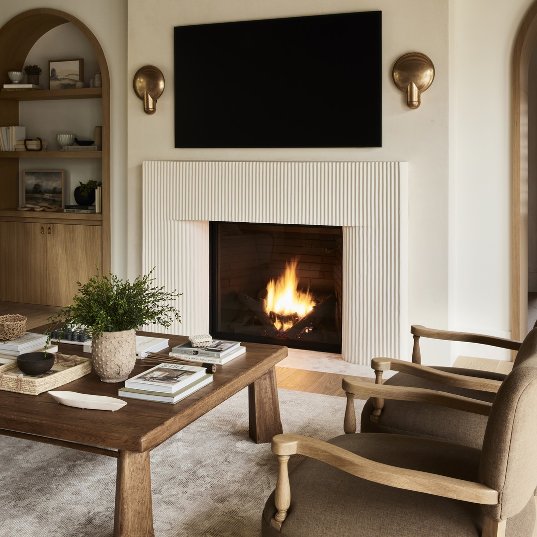 a living room filled with furniture and a fire place