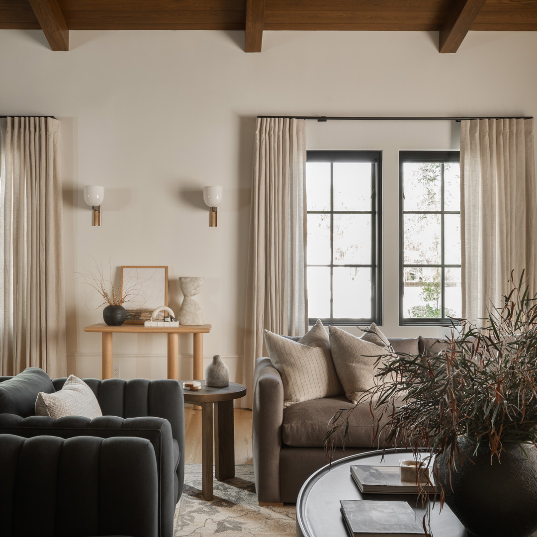 a living room filled with furniture and a large window