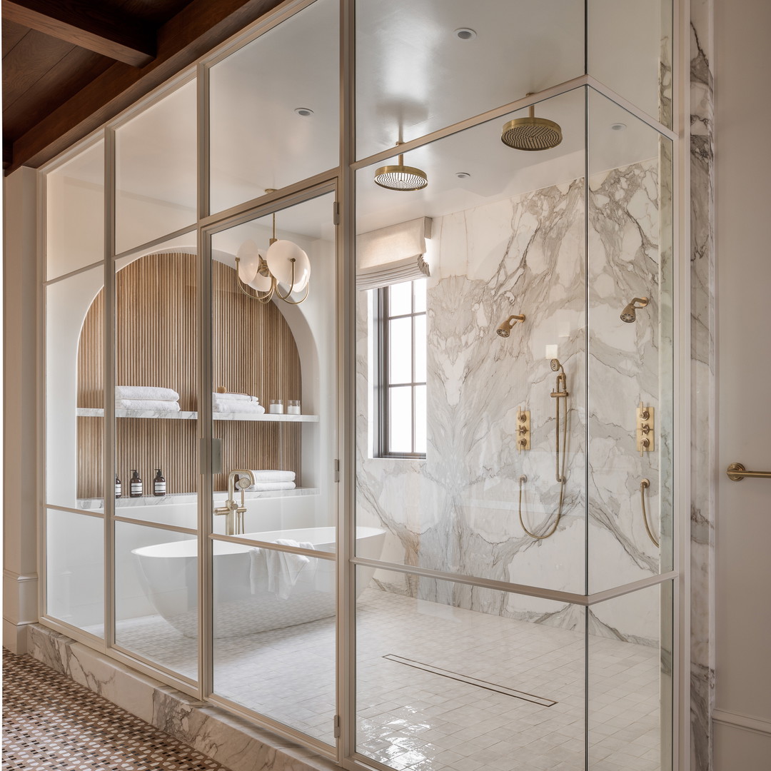 a bathroom with a walk in shower next to a sink