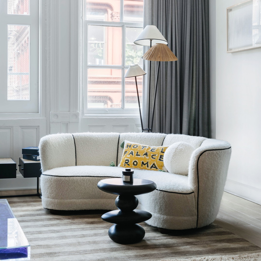 a living room filled with furniture and a lamp