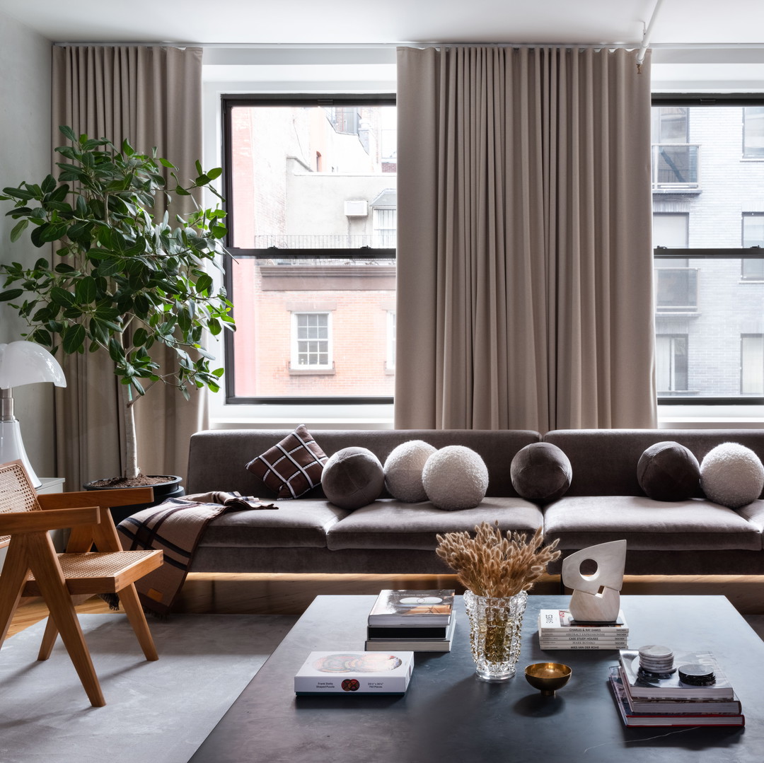 a living room filled with furniture and a large window