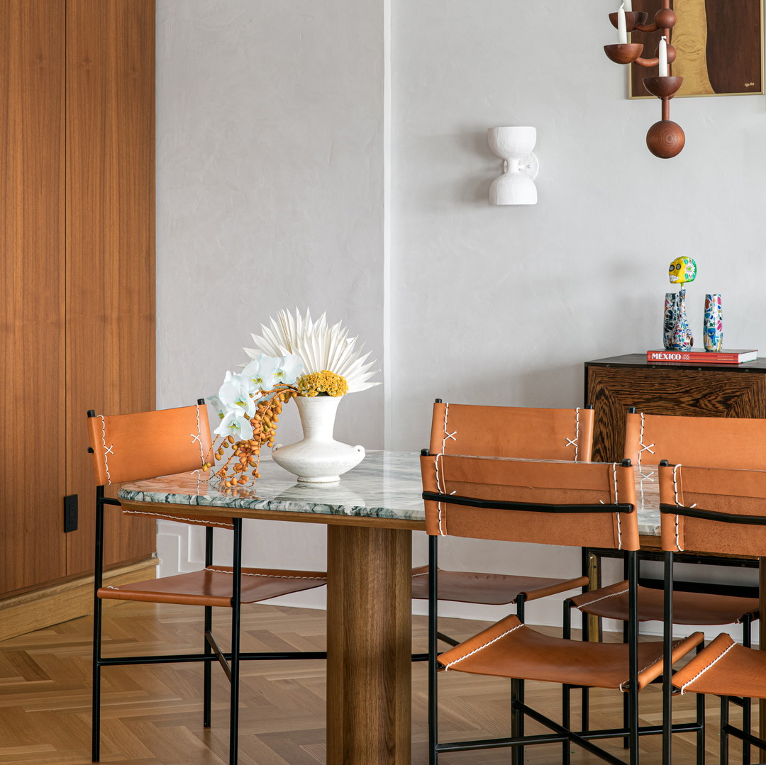 a dining room table with a vase of flowers on it