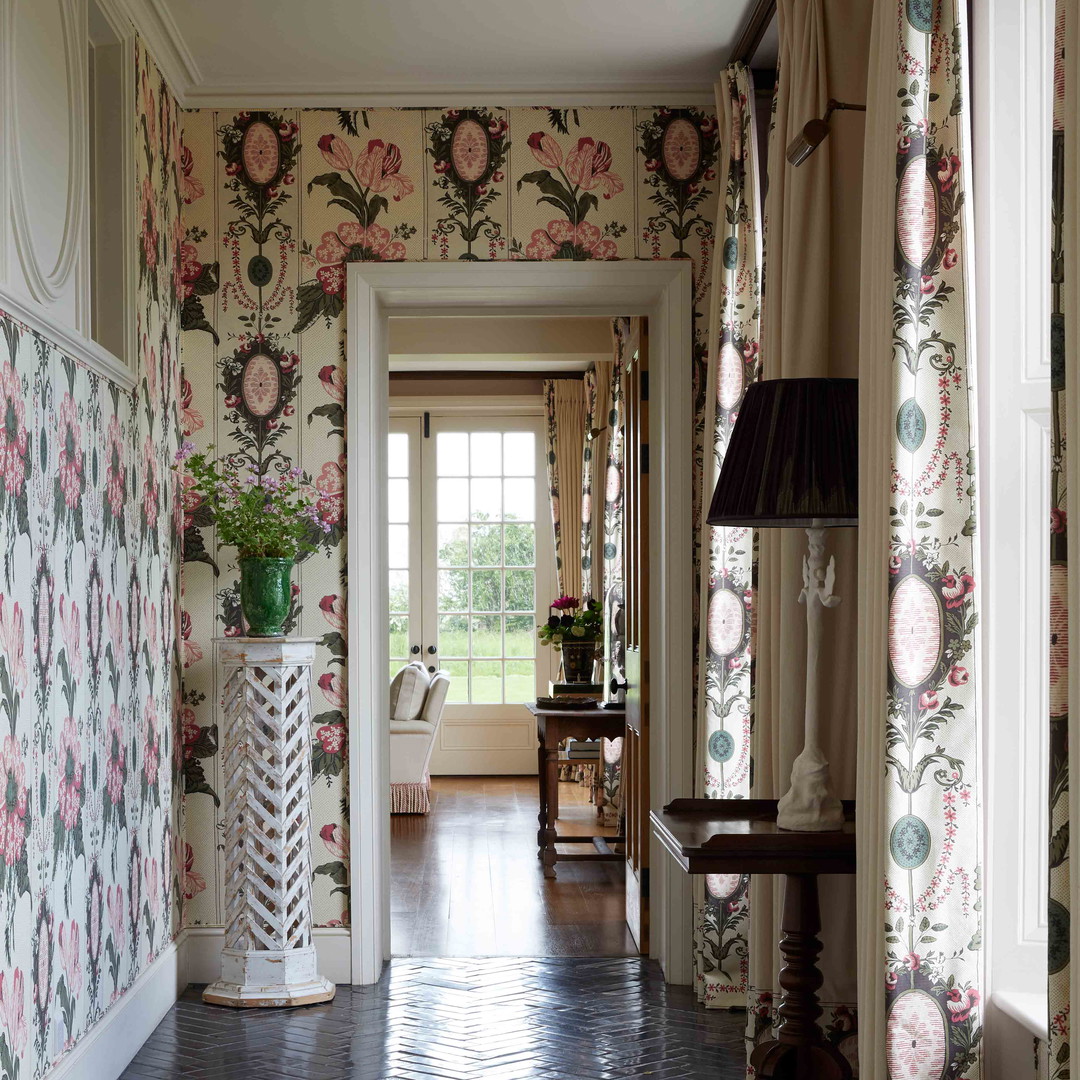 a hallway with a vase of flowers on the wall