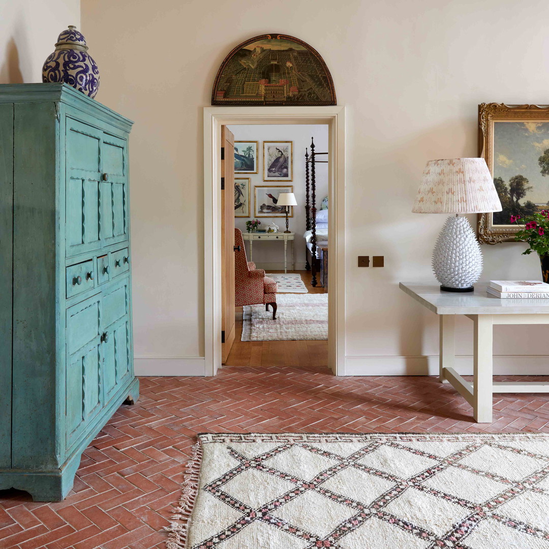 a living room with a blue cabinet and a rug