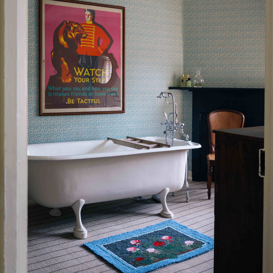 a bathroom with a bathtub and a rug on the floor