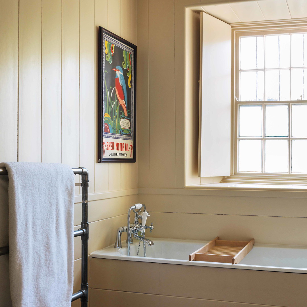 a bathroom with a bathtub and a towel rack