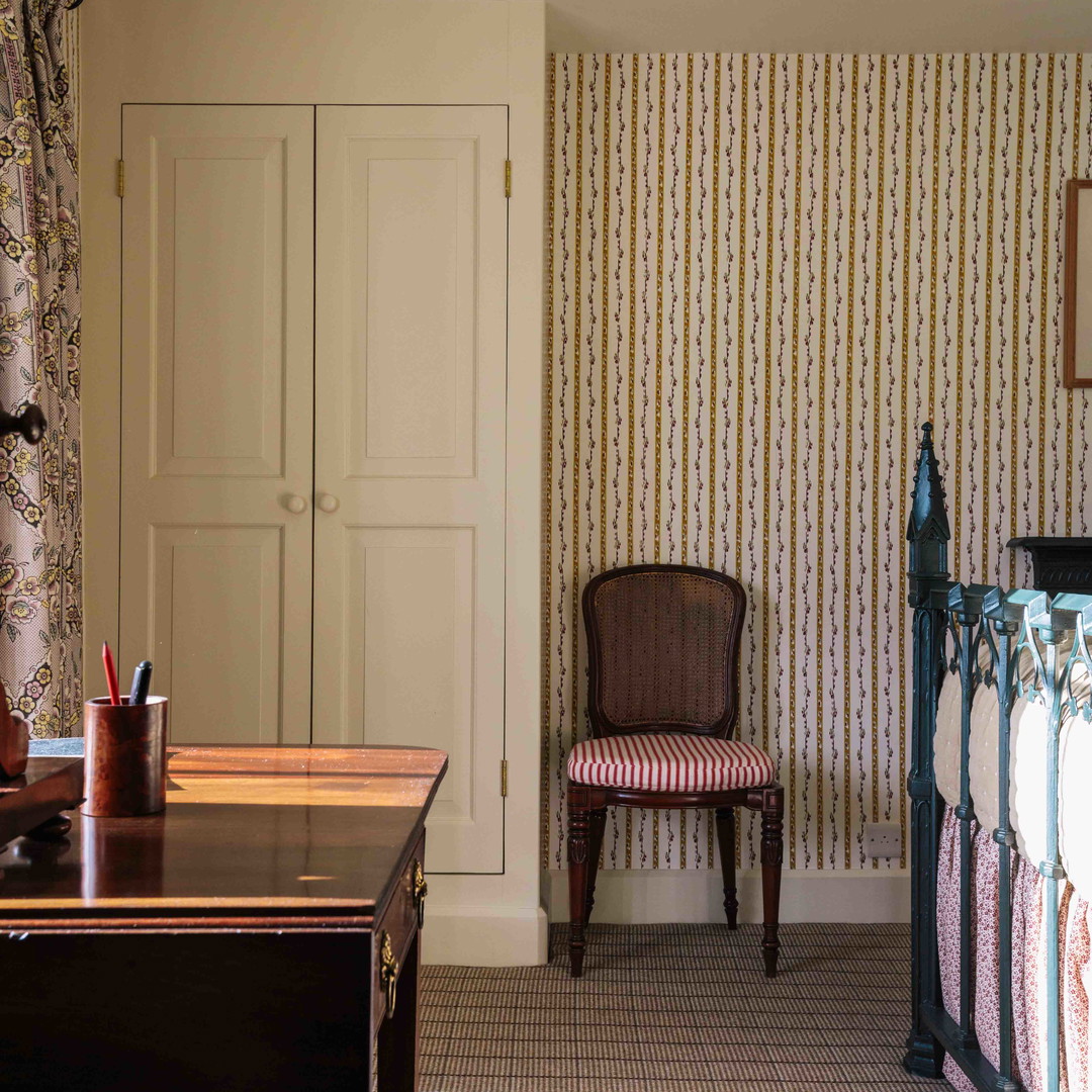 a bedroom with a desk, chair and closet