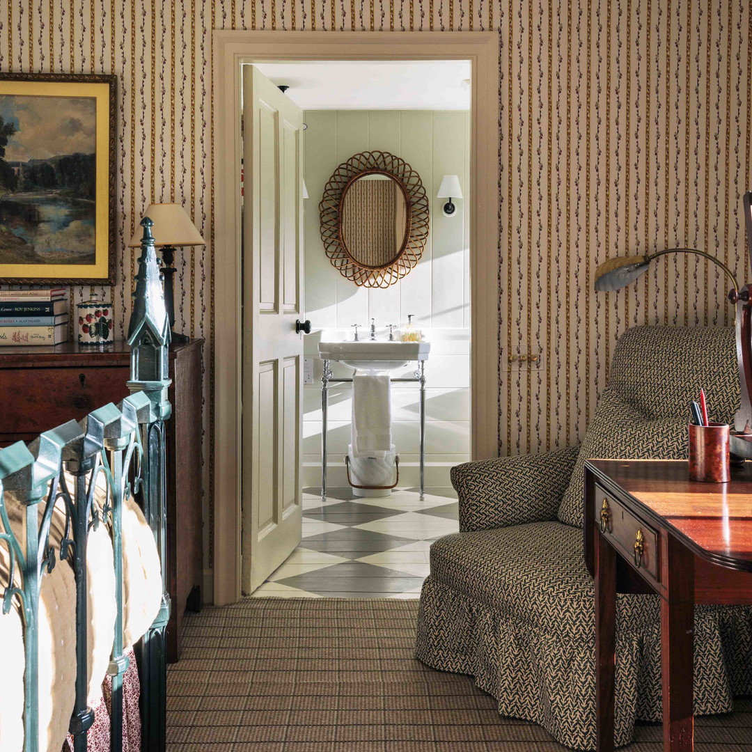 a baby crib in a room with a painting on the wall