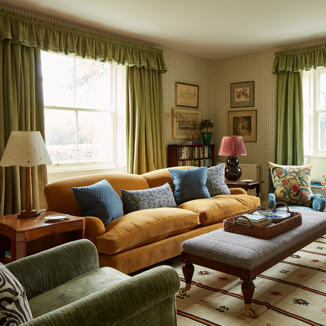 a living room filled with furniture and a large window