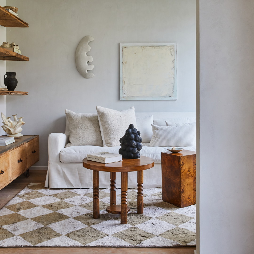 a living room filled with furniture and a checkered rug