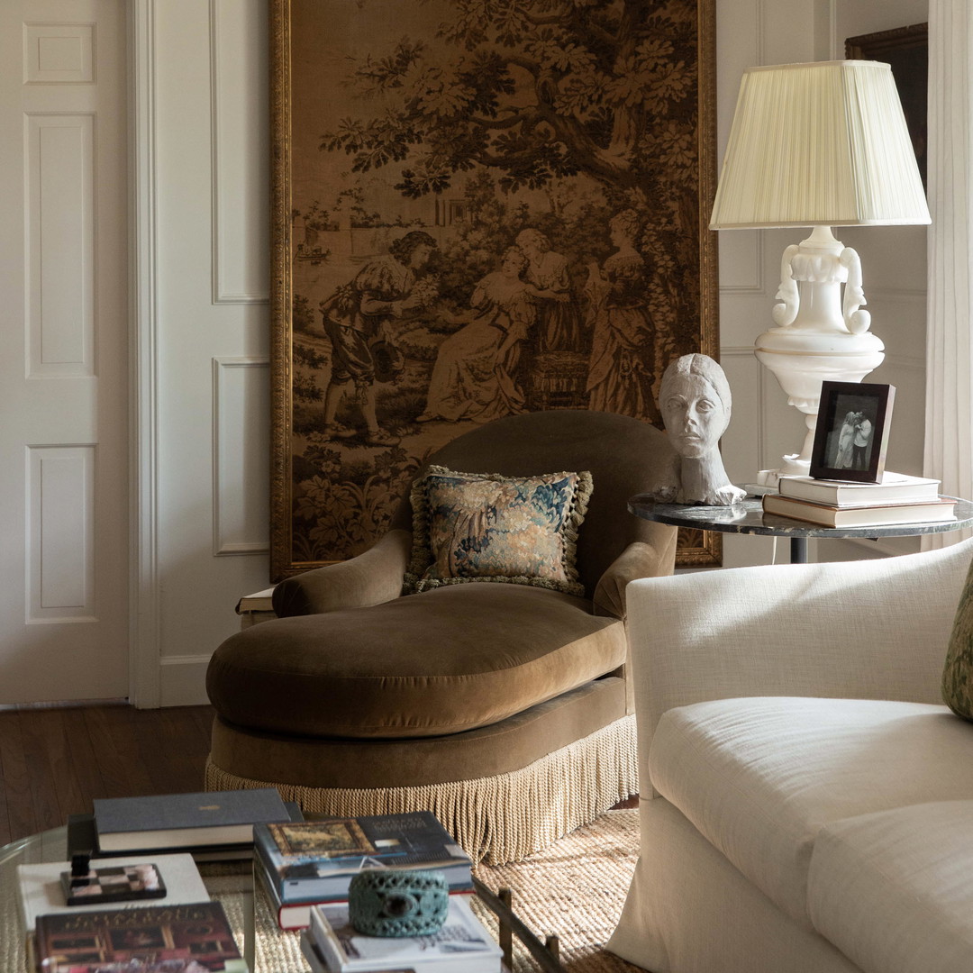 a living room filled with furniture and a painting on the wall