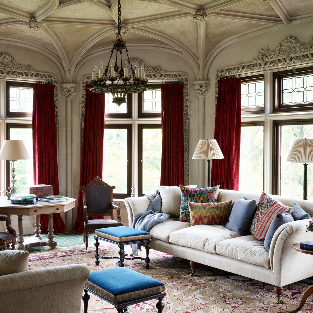 a living room filled with furniture and a chandelier